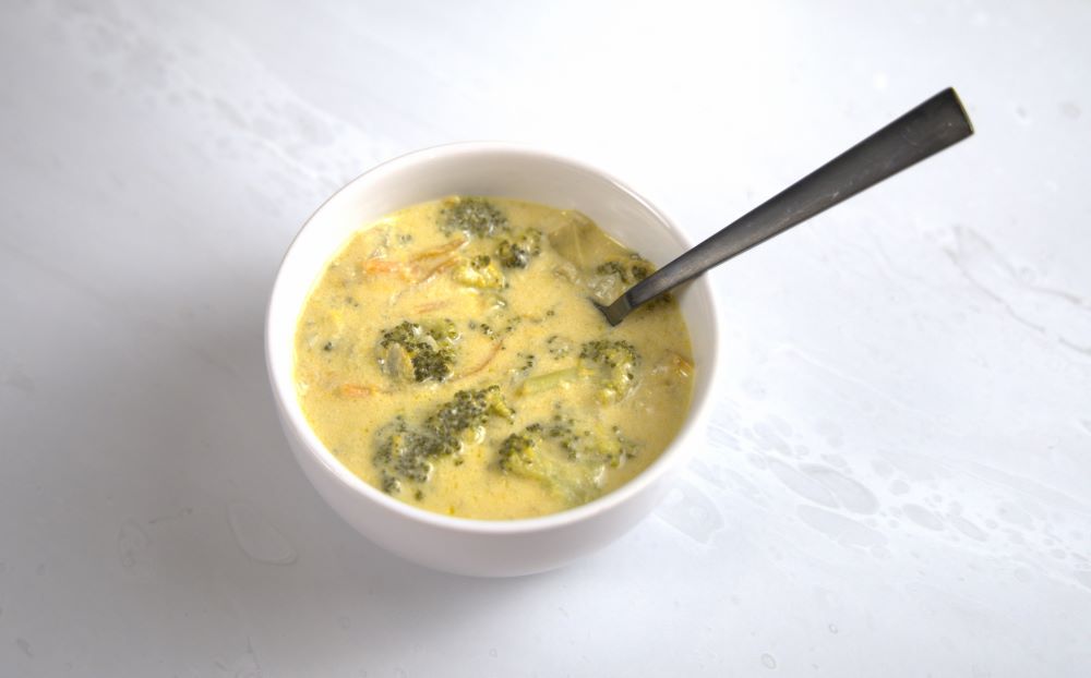 broccoli cheddar soup in a bowl with spoon